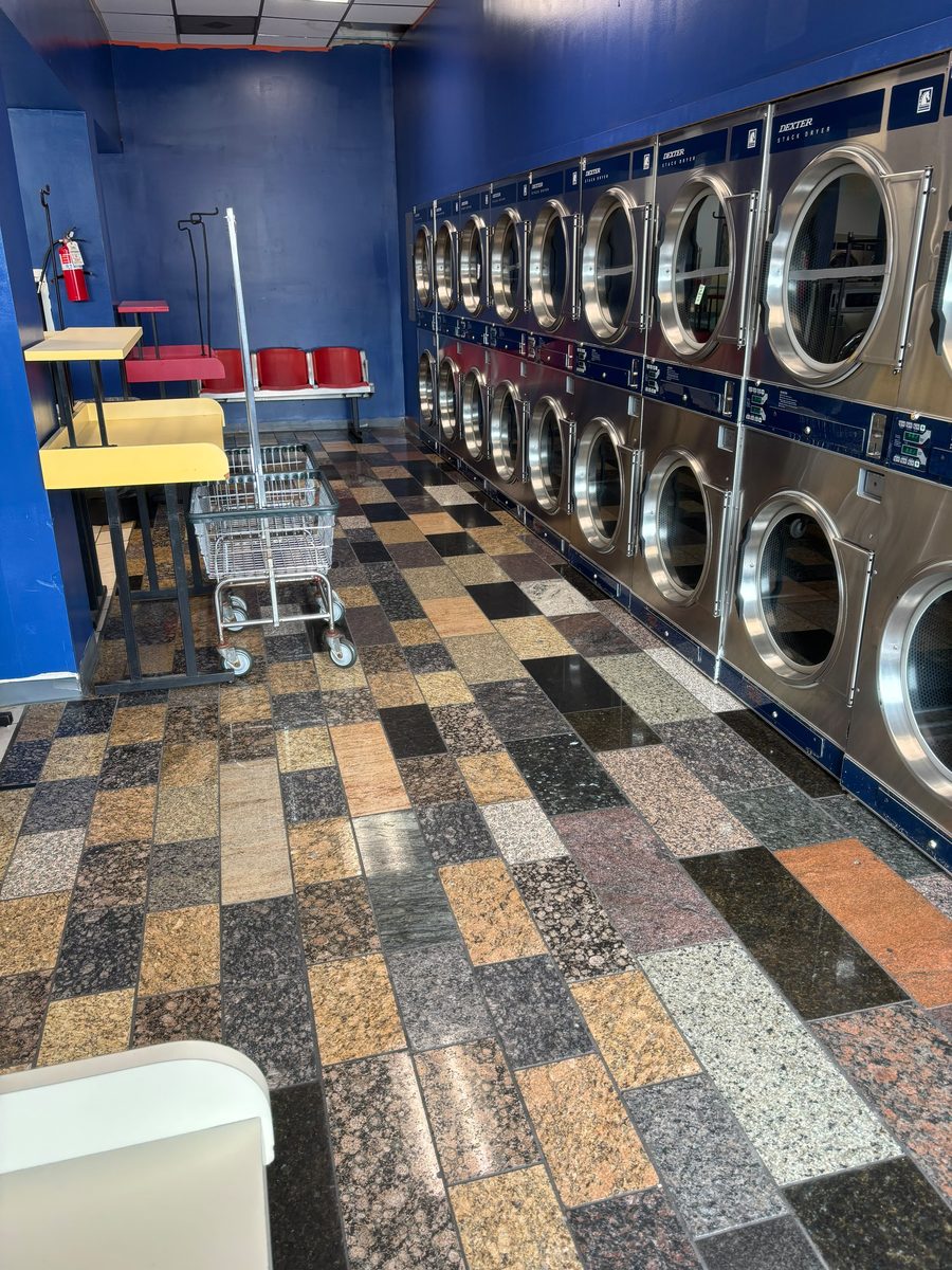 The dryer bank and folding area at Laundry Station